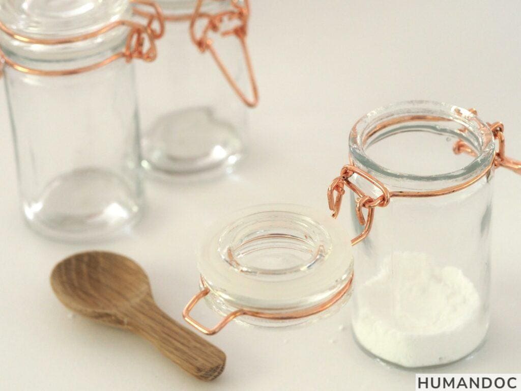 open glass jar near brown wooden spatula