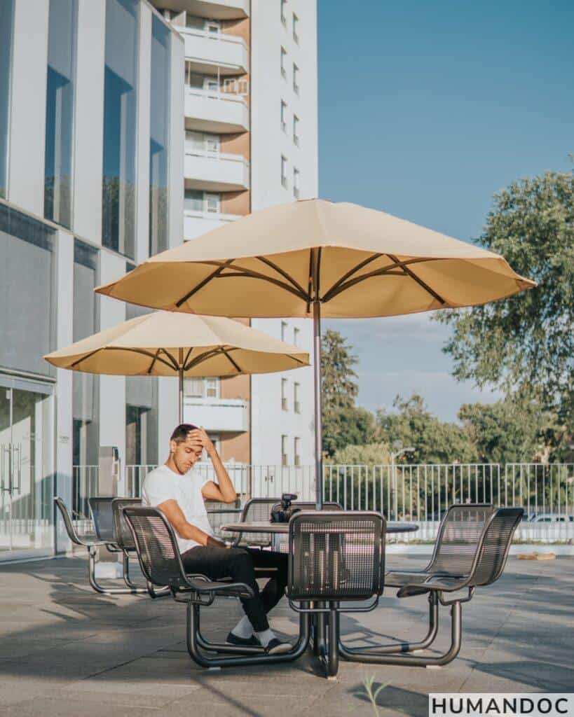 man sitting on black metal chair