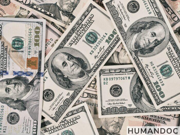 a pile of twenty dollar bills laying on top of each other